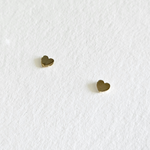 Flat lay of Mini Heart Studs on neutral background