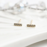 Bar-shaped gold earrings with embedded cubic zirconia details