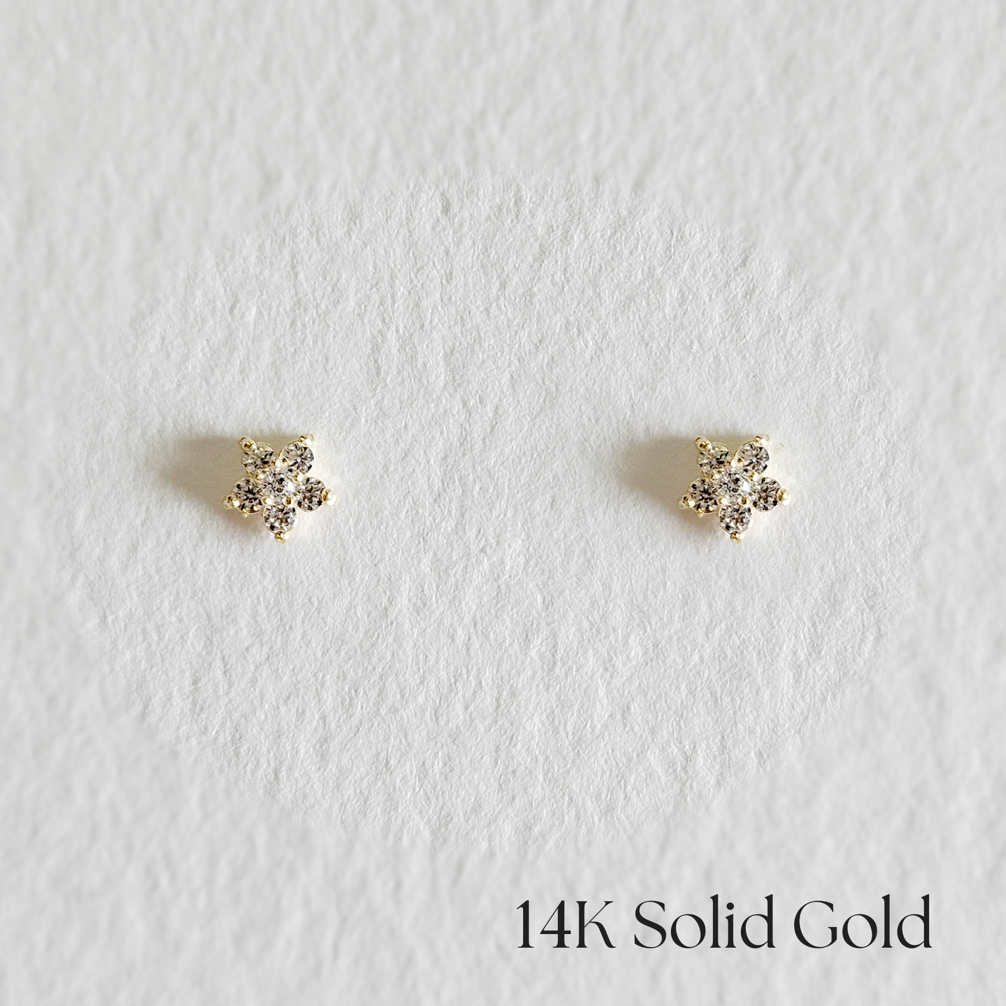 Front view of Tiny Fiore earrings in 14K gold with floral design