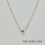 Front-facing image of full necklace – bezel diamond pendant centered on fine gold chain