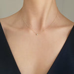 Model wearing bezel diamond pendant Necklace – pendant resting gently at collarbone for a refined look