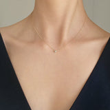 Model wearing bezel diamond pendant Necklace – pendant resting gently at collarbone for a refined look