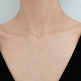 Model wearing the Diamond Accent Necklace with a V neck top, showcasing its dainty elegance.