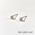 Pair of gold stud earrings with diamonds on a white background, labeled '14K Solid Gold'.