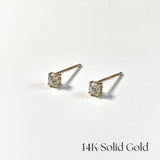 Pair of gold stud earrings with diamonds on a white background, labeled '14K Solid Gold'.
