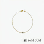 Gold bracelet on a white background with '14K Solid Gold' text.