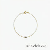 Gold bracelet on a white background with '14K Solid Gold' text.