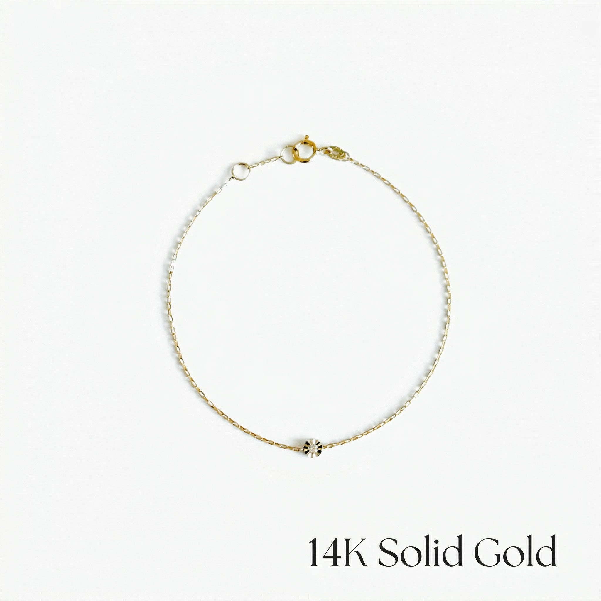 Gold bracelet on a white background with '14K Solid Gold' text.
