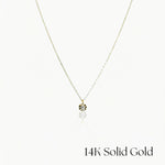 Gold necklace with a small pendant on a white background, labeled '14K Solid Gold'.