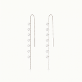 Pair of silver chain earrings with small round pendants on a white background