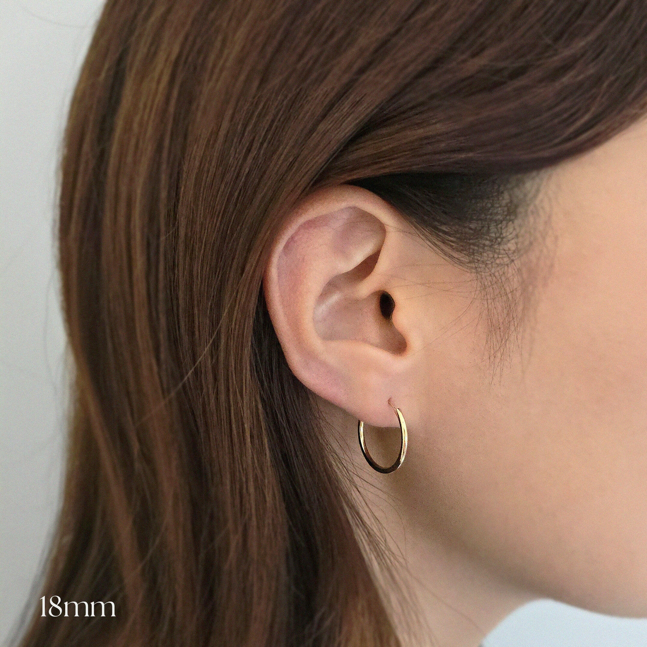 Subtle Hoops Model wearing 18mm gold hoops for subtle, everyday elegance