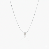 Necklace with a round pendant on a white background
