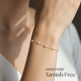 Gold filled bracelet on a wrist with 'GOLD FILLED Tarnish Free' text.