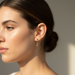 Close-up of a woman wearing gold earrings with a blurred background