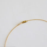 Gold bracelet on a light gray background