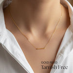 Gold filled necklace on a person wearing a white shirt with 'GOLD FILLED Tarnish Free' text.