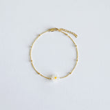 Small mother of pearl daisy charm on Dainty gold chain 
