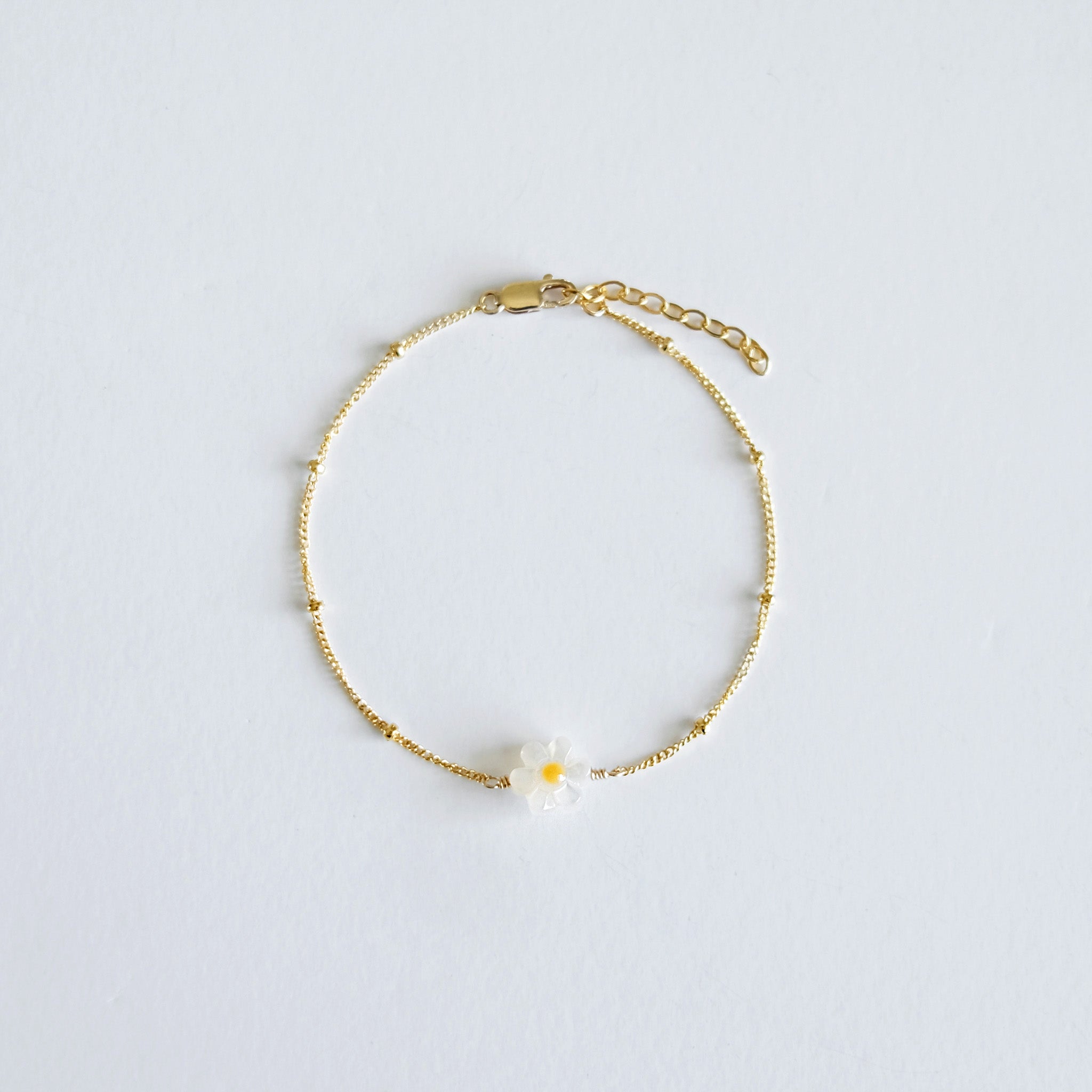 Small mother of pearl daisy charm on Dainty gold chain 