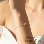 Gold filled bracelet with pearls on a wrist, labeled 'Tarnish Free'.