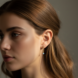 Close-up of a woman wearing an earring with a neutral background