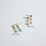 Pair of earrings with pink opal and amazonite stones on a light gray background