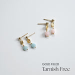 Gold-filled earrings with pink and blue beads on a light gray background