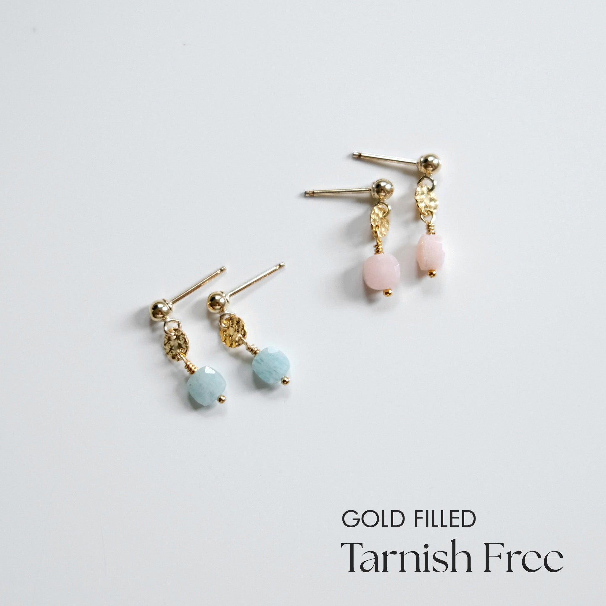 Gold-filled earrings with pink and blue beads on a light gray background