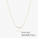 Gold-filled necklace with pearls on a white background