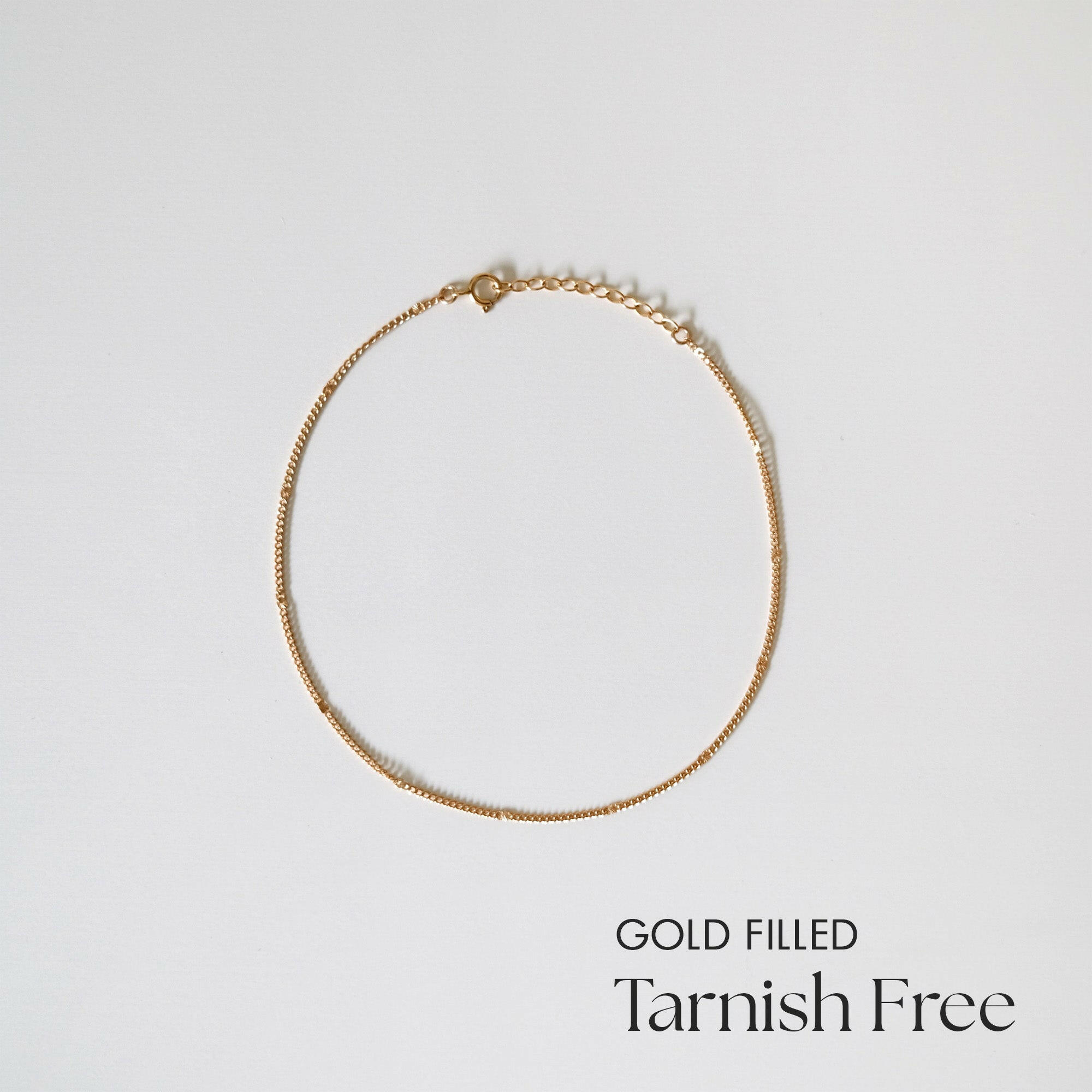 Minimalist gold-filled Ally Chain Anklet laid flat on white background, showcasing dainty design