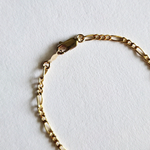 Zoomed-in view of lobster clasp and end links on Figaro bracelet