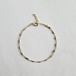 Flat lay of Bonbon Bracelet showcasing unique gold chain texture