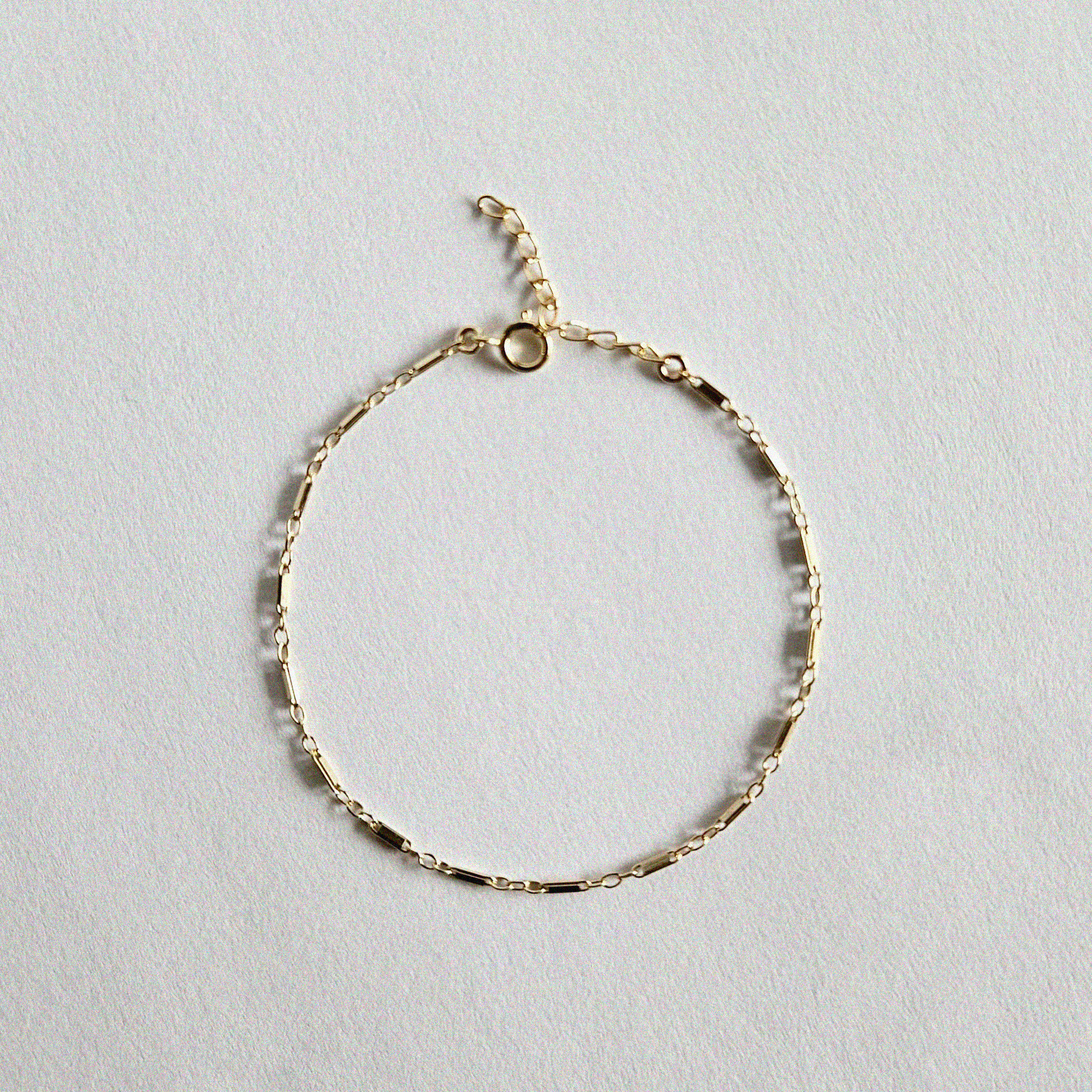 Flat lay of Bonbon Bracelet showcasing unique gold chain texture