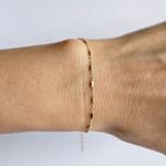 Top view of wrist featuring unique gold bracelet with subtle shine
