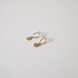 Side profile of Celina Disc Earrings highlighting flat disc shape