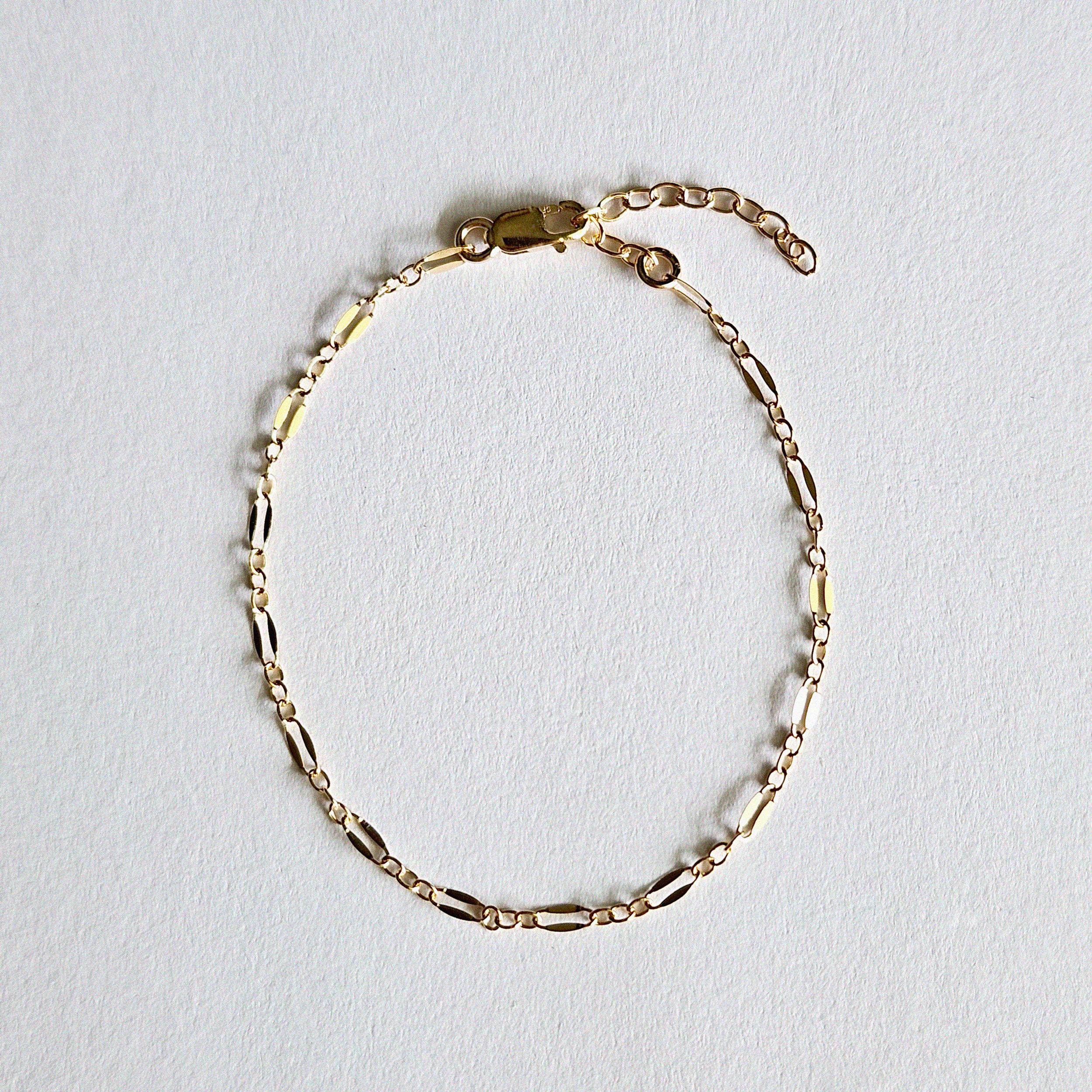 Flat lay of Coffee Bean Bracelet highlighting its distinct oval-shaped links