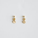 Pair of gold earrings on a light gray background