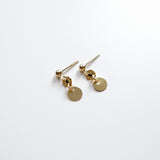 Gold earrings with round pendants on a white background