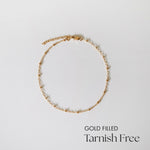 Gold-filled Dotty Chain II Anklet laid flat on white surface showing even bead spacing