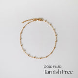 Gold-filled Dotty Chain II Anklet laid flat on white surface showing even bead spacing