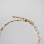Close-up of gold-filled lobster clasp and extension chain on Dotty Anklet showing polished finish