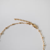Close-up of gold-filled lobster clasp and extension chain on Dotty Anklet showing polished finish