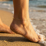 Close-up of a foot with sand on a beach
