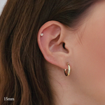 Model wearing 15mm gold-filled flex hoops for a minimal everyday look