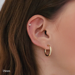 Model wearing 18mm gold-filled flex hoops for a minimal everyday look