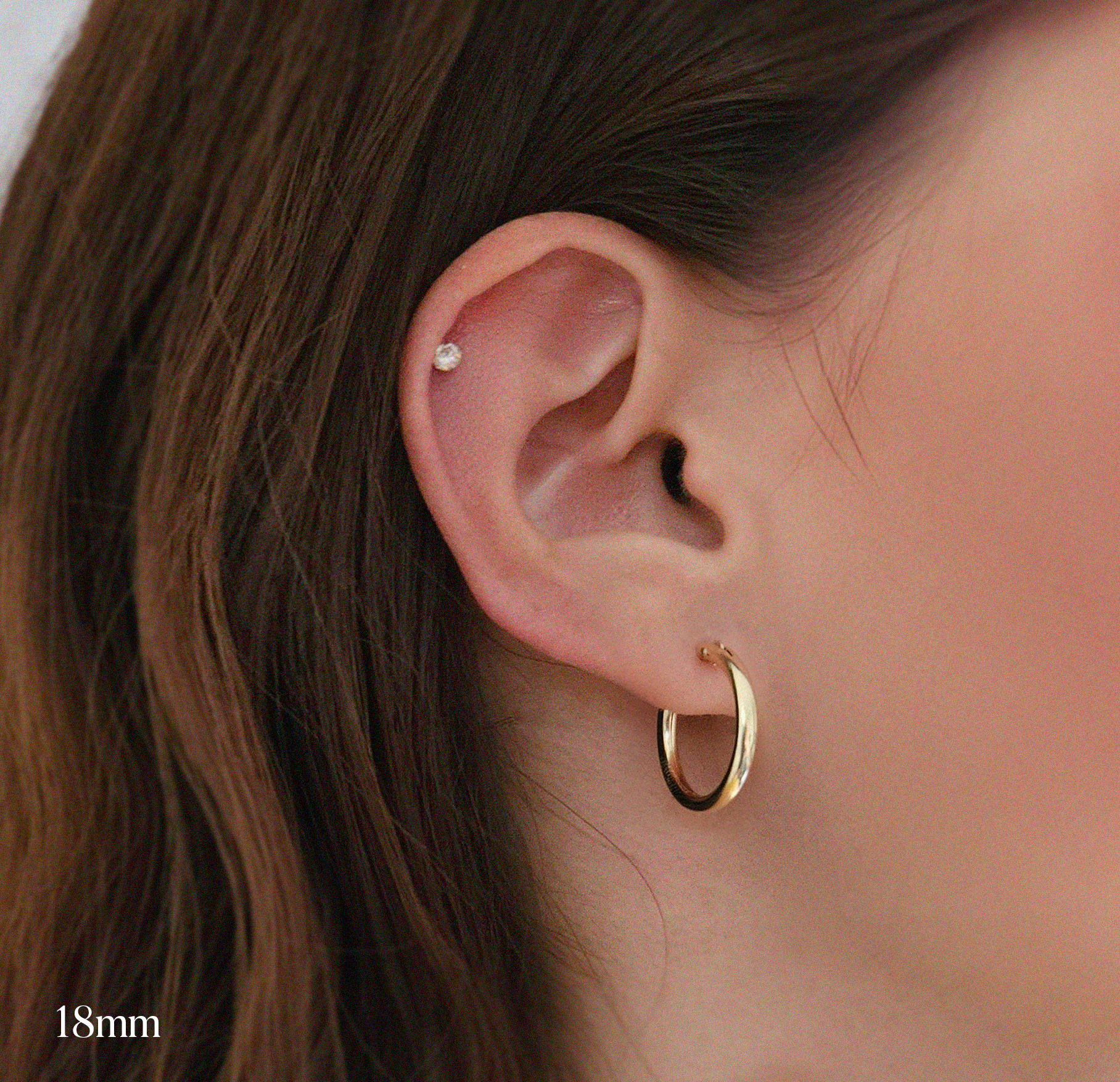 Model wearing 18mm gold-filled flex hoops for a minimal everyday look