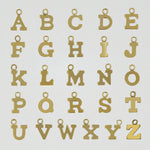 A to Z gold-filled initial charms displayed flat on a white surface.