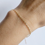 Model’s wrist wearing Kos Chain Bracelet alone in minimalist styling
