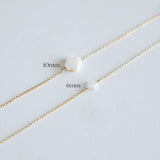 Two gold chains with clover-shaped mother of pearls, one labeled '10mm' and the other '6mm', on a light gray background.