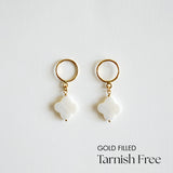 Gold-filled clover pendant earrings on a light gray background