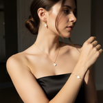 Woman wearing a delicate necklace and bracelet with a blurred background